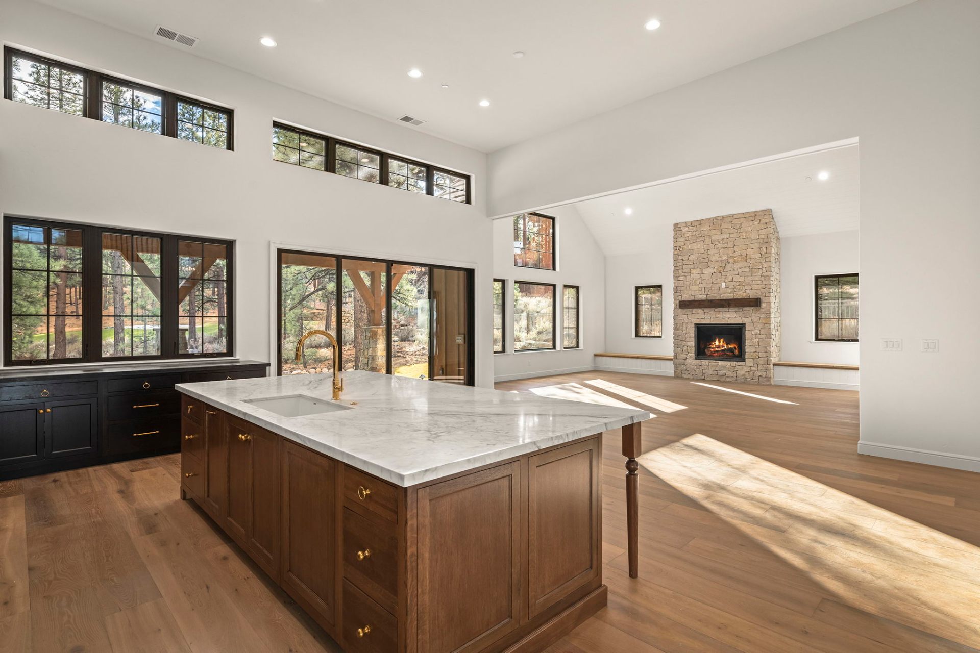 Kitchen and hearth room with floor-to-ceiling stone fireplace