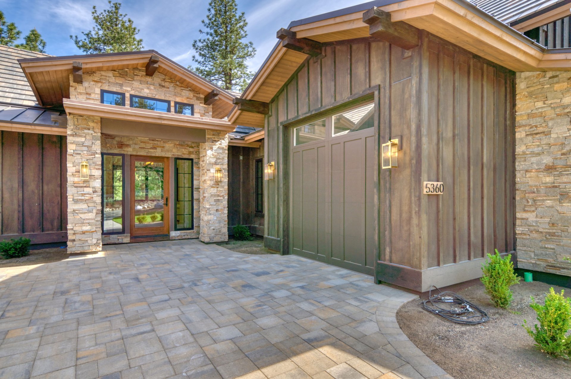 Front entry detail with paired timber garage doors