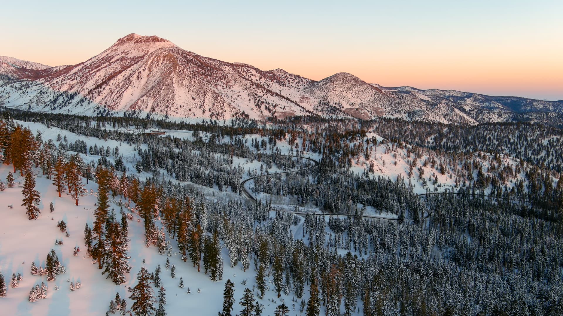 Snow-covered Sierra Nevada peaks and pine forest at sunrise near Mt. Rose